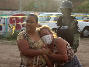 Women react outside a drug rehabilitation facility where assailants killed several people, according to Guanajuato state police, in Irapuato, Mexico July 1, 2020.