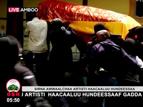 Mourners carry the coffin of Ethiopian musician Haacaaluu Hundeessaa during his funeral in Ambo, Ethiopia, July 2, 2020, in this still image from a video.