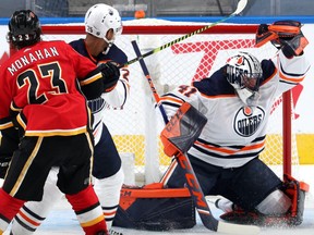 Goaltender Mike Smith #41 of the Edmonton Oilers makes a glove save during the second period of the exhibition game against Calgary Flames prior to the 2020 NHL Stanley Cup Playoffs at Rogers Place on July 28, 2020 in Edmonton.