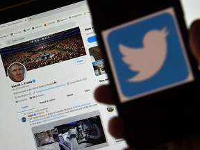 In this photo illustration, a Twitter logo is displayed on a mobile phone with President Trump's Twitter page shown in the background on May 27, 2020, in Arlington, Virginia.