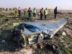 In this file photo taken on January 08, 2020 rescue teams are seen on January 8, 2020 at the scene of a Ukrainian airliner that crashed shortly after take-off near Imam Khomeini airport in the Iranian capital Tehran.