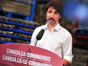 In this file photo taken on July 3, 2020 Prime Minister Justin Trudeau speaks to the press as he volunteers at the Moisson Outaouais food bank in Gatineau, Que., during the coronavirus pandemic.