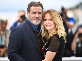 In this file photo taken on May 15, 2018 actor John Travolta (L) and his wife actress Kelly Preston pose during a photocall for the film "Gotti" at the 71st edition of the Cannes Film Festival in Cannes, southern France.
