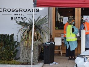 Medical workers are seen at a COVID-19 coronavirus testing station at the Crossroads Hotel, a popular drinking spot where at least 21 infections had been linked to a cluster there, in Sydney on July 13, 2020.