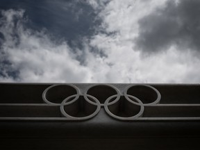 This file photo taken on June 8, 2020 shows the Olympic rings logo at the entrance of the headquarters of the International Olympic Committee (IOC) in Lausanne, Switzerland.