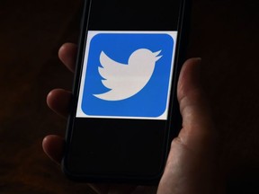In this file photo illustration, a Twitter logo is displayed on a mobile phone on May 27, 2020, in Arlington, Virginia.