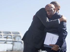 In this file photo taken on March 7, 2015, U.S. President Barack Obama, right, hugs U.S. Representative John Lewis, Democrat of Georgia, one of the original marchers at Selma, during an event marking the 50th Anniversary of the Selma to Montgomery civil rights marches at the Edmund Pettus Bridge in Selma, Alabama.