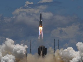 A Long March-5 rocket, carrying an orbiter, lander and rover as part of the Tianwen-1 mission to Mars, lifts off from the Wenchang Space Launch Centre in southern China's Hainan Province on July 23, 2020.