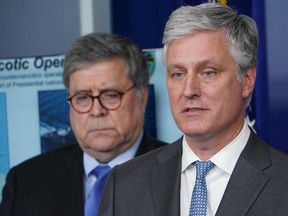 In this file photo, National Security Advisor Robert O'Brien (right) speaks while U.S. Attorney General William Barr listens during the daily briefing on the novel coronavirus, COVID-19, in the Brady Briefing Room at the White House on April 1, 2020, in Washington, D.C.