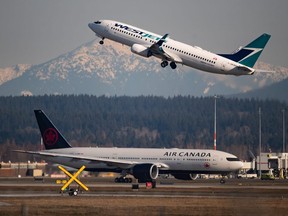 An Air Canada flight departing for Toronto, bottom, taxis to a runway as a Westjet flight bound for Palm Springs takes off at Vancouver International Airport, in Richmond, B.C., on Friday, March 20, 2020.