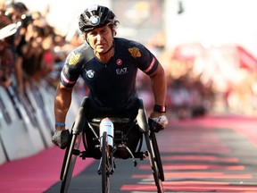 Alex Zanardi of Italy crosses the finish line during an Ironman race, in Cervia, Italy, Sept. 21, 2019.