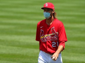 Andrew Miller of the St. Louis Cardinals returns to the dugout during the first day of summer workouts at Busch Stadium on July 3, 2020 in St. Louis.