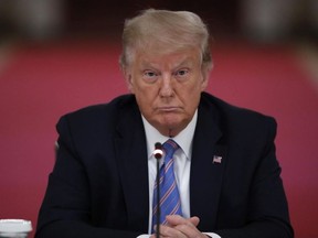 President Donald Trump listens during a "National Dialogue on Safely Reopening America's Schools," event in the East Room of the White House, Tuesday, July 7, 2020, in Washington.