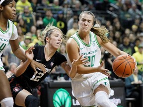 Oregon Ducks guard Sabrina Ionescu (20) drives to the basket as Stanford Cardinal guard Lexie Hull (12) defends during the second half at Matthew Knight Arena.