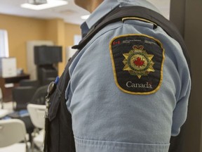 A Correctional Services Canada officer stands at the entrance to the media overflow viewing area at Bath Institution federal medium security correctional facility in Bath, Ont. on Wednesday October 17, 2018.