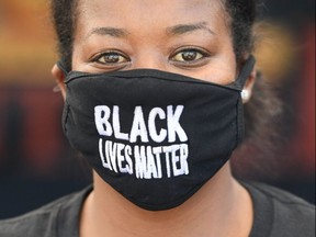 Food bank volunteer Kristian Huling poses for a photo wearing a Black Lives Matter mask at a free community food bank in the Crenshaw neighbourhood of Los Angeles, Saturday, July 18, 2020.
