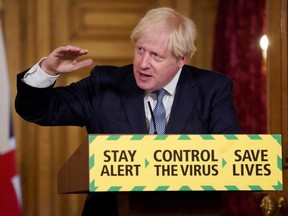 A handout image released by 10 Downing Street, shows Britain's Prime Minister Boris Johnson attending a remote press conference to update the nation on the COVID-19 pandemic inside 10 Downing Street in London, Friday, July 31, 2020.