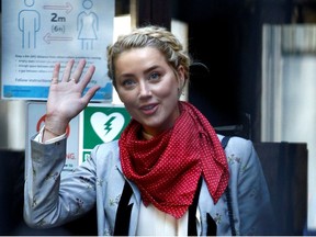 Actor Amber Heard waves as she arrives at the High Court in London, Britain, July 21, 2020.