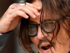 Actor Johnny Depp reacts as he arrives at the High Court in London, Britain July 13, 2020.