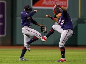 Minnesota Twins left fielder Eddie Rosario (20) and Twins centre fielder Byron Buxton (25) celebrate after defeating the Boston Red Sox at Fenway Park.
