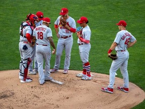 Cardinals starting pitcher Carlos Martinez (18) and infield players talk during the first inning against the Twins at Target Field, in Minneapolis, Tuesday, July 28, 2020.