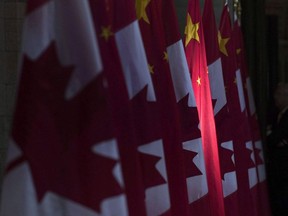 A Chinese flag is illuminated by sunshine in the Hall of Honour on Parliament Hill in Ottawa, Thursday, September 22, 2016.