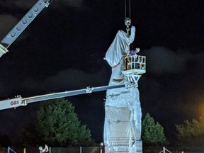 A statue of Christopher Columbus at Grant Park in Chicago is removed early on Friday, July 24, 2020.