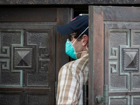 A plain clothes U.S. security official enters the back door of China’s Consulate after employees left the building in Houston July 24, 2020.