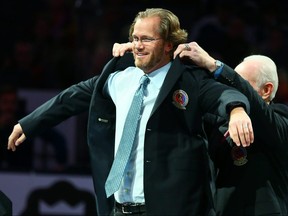 Hockey Hall of Fame Chairman Lanny McDonald puts the Hall of Fame jacket on Chris Pronger in Toronto on November 8, 2015.