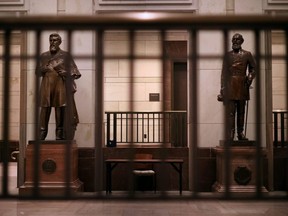 Statues of James Zachariah George (left), a colonel in the Confederate Army and Senator from Mississippi, and Edmund Kirby Smith, a native Floridian and a Confederate general, stand inside the U.S. Capitol Visitors Center June 18, 2020 in Washington.