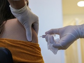 Handout photo released by the Sao Paulo State Government press office shows a volunteer receiving a potential COVID-19 vaccine during the trial stage of the vaccine produced by the Chinese company Sinovac Biotech at the Hospital das Clinicas in Sao Paulo state, Brazil, Tuesday, July 21, 2020.