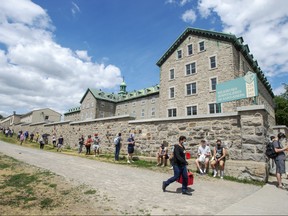 Hundreds of people line up at the Hotel Dieu COVID-19 testing clinic Wednesday, July 15, 2020 in Montreal. The city has recommended that anyone who has been in a bar since July 1, 2020 to get tested.