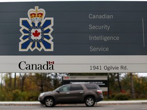 A vehicle passes a sign outside the Canadian Security Intelligence Service  headquarters in Ottawa, November 5, 2014.