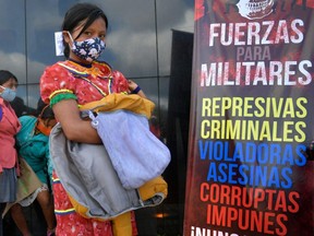Embera women protest against the Colombian army, after seven soldiers admitted that they sexually abused a girl from their community, in Bogota on June 26, 2020.
