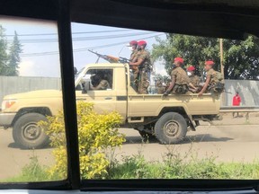 Ethiopian military ride on their pick-up truck as they patrol the streets following protests in Addis Ababa, Ethiopia July 2, 2020.