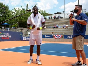 Frances Tiafoe does a socially-distanced interview following his win over Sam Querrey during the DraftKings All-American Team Cup in Atlanta, Friday, July 3, 2020.