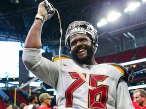 Donovan Smith of the Tampa Bay Buccaneers gestures to fans during the second half of a game against the Atlanta Falcons at Mercedes-Benz Stadium on Nov. 24, 2019 in Atlanta, Ga.