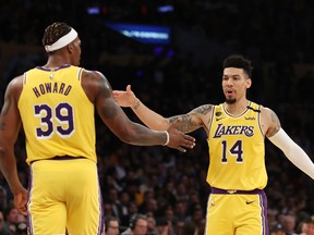 Danny Green, right, and Dwight Howard of the Los Angeles Lakers react to a play in a game against the New Orleans Pelicans during the second half at Staples Center on Feb. 25, 2020 in Los Angeles, Calif.