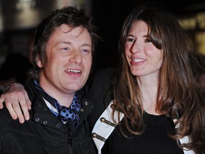 British chef Jamie Oliver and his wife Jools smile as they arrive to the European premiere of new movie "Kick-Ass" in London on March 22, 2010.