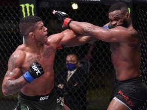 In this handout provided by UFC, Gilbert Burns (left) punches Tyron Woodley in their welterweight fight during the UFC Fight Night event at UFC APEX on May 30, 2020 in Las Vegas.