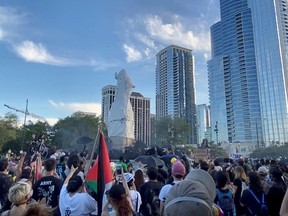 Protesters surround a statue of Christopher Columbus at Grant Park in Chicago, Illinois, U.S., July 17, 2020, in this still image from video obtained via social media.