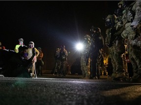 Federal law enforcement officers face off with protesters during a demonstration against police violence and racial inequality in Portland, Oregon, U.S., July 30, 2020.