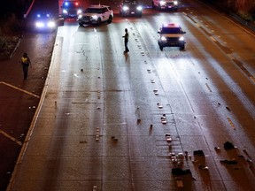 Washington State Troopers investigate the scene where two people in a group of protesters were struck by a car on Interstate 5 while the highway was closed to traffic due to the protest in Seattle, Washington, U.S., July 4, 2020.