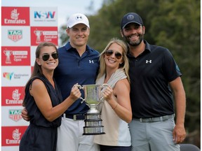 Jordan Spieth of the United States (2nd L) poses with the Stonehaven Cup after winning the Australian Open alongside his girlfriend Annie Verret (L), his caddie Michael Greller (R) and Greller's wife Ellie.