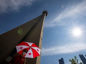 An employee waits to direct people to the entrance of the 553 metres (1815 feet) high CN Tower, which reopened for the first time since the coronavirus disease (COVID-19) restrictions were imposed in Toronto, Ontario, Canada July 15, 2020.