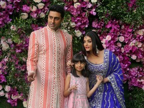 FILE PHOTO: Indian film actor Abhishek Bachchan, his wife Aishwarya Rai and their daughter Aaradhya in a 2019 photograph taken at the wedding of  Akash Ambani, the son of Reliance Industries chairman Mukesh Ambani, in Mumbai, India. Picture taken on March 9, 2019. REUTERS/Francis Mascarenhas/File Photo ORG XMIT: FW1