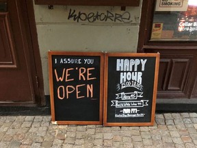 A sign assures people that the bar is open during the coronavirus outbreak, outside a pub in Stockholm, Sweden March 26, 2020.