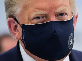 U.S. President Donald Trump wears a protective face mask during a tour of the Fujifilm Diosynth Biotechnologies' Innovation Center, a pharmaceutical manufacturing plant where components for a potential coronavirus disease  (COVID-19) vaccine candidate are being developed, in Morrrisville, North Carolina, U.S., July 27, 2020.