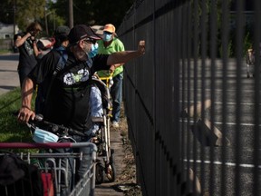 Perryn Flint, 60, stands in line to collect groceries distributed by the Wesley Community Center to residents affected by the economic fallout from the coronavirus disease (COVID-19) outbreak in Houston, Texas, U.S., July 31, 2020.