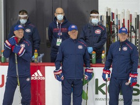 Canadiens head coach Claude Julien, centre, is flanked by assistant coaches Kirk Muller, left, and Domenic Ducharme, right, while watching practice at the Bell Sports Complex in Brossard on Monday.